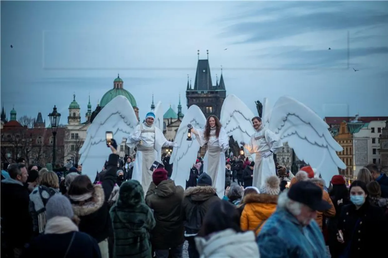 Prague, Czech Republic, 05 December 2021. Three artists walked on stilts and wished a Merry Christmas to people