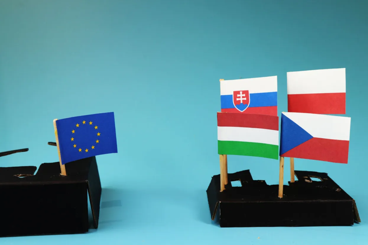 A one side Vysegrad four fighting for own interest and on the second side Europe union figting for nothing. Blue background